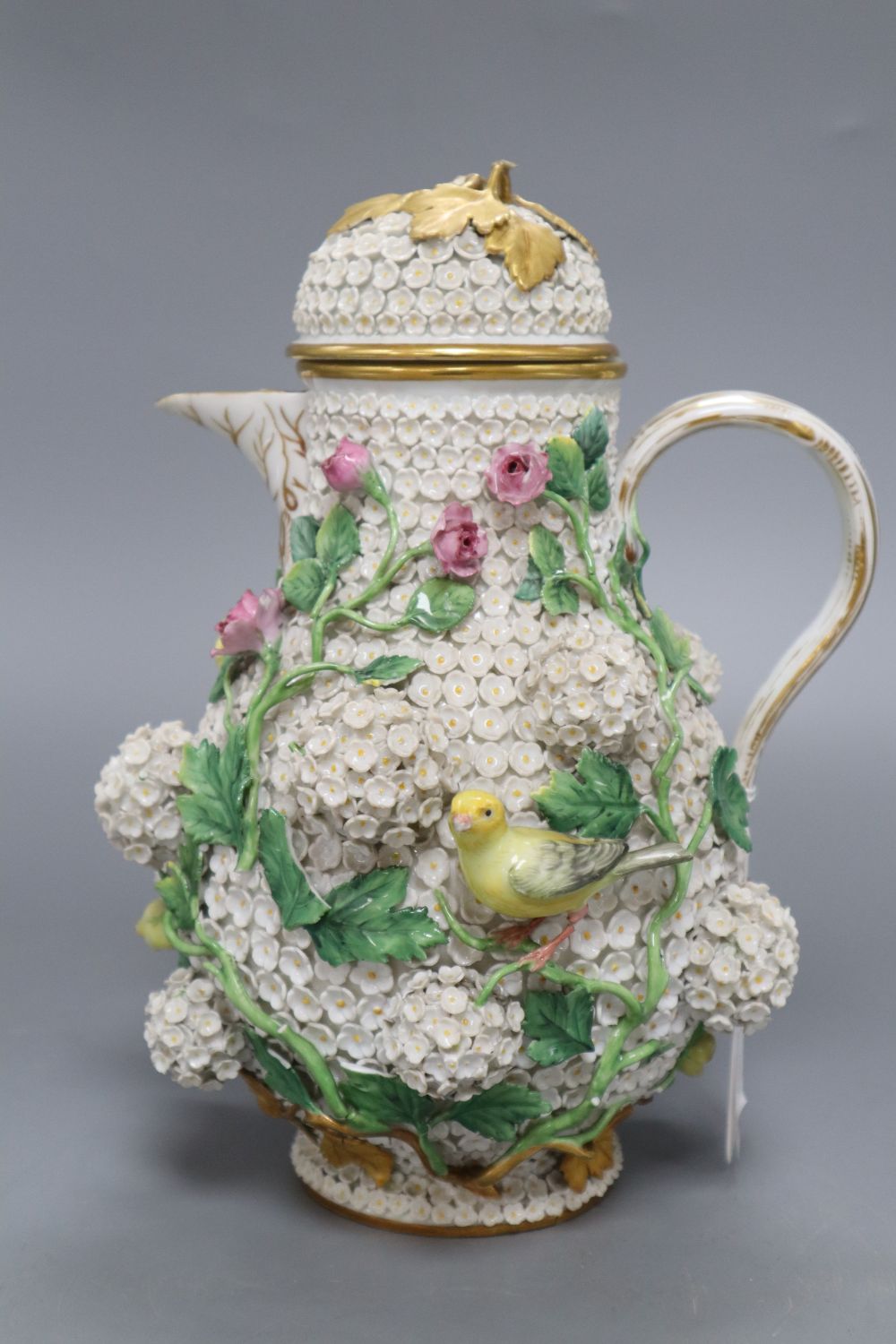 A Meissen floral encrusted hot water jug and cover, height 26cm